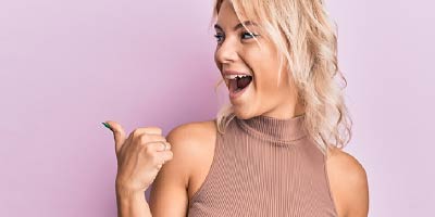 Young woman using mobile phone to profile verify with hand gesture