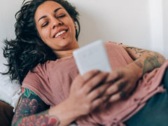 Lesbian sending a message on her mobile device