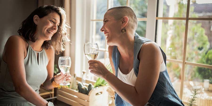 Lesbian couple sharing a wine on a first date 